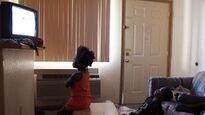 A couple Black children watching the tele